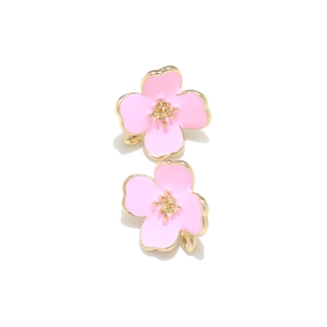 Macro detail of pink enamel cherry blossom stud earrings with gold-plated metal flower stamens