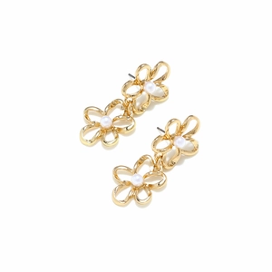 Close-up of gold-plated double flower earrings featuring white pearls and sleek curves