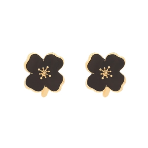 Detail shot of black enamel flower earrings with golden core and leaf accent