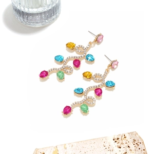 Macro shot of colorful pear-cut crystal drops on rhinestone-encrusted vine drop earrings