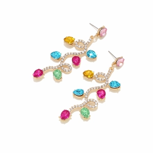 Macro shot of gold-plated earrings with pave diamonds and colorful pear-cut rhinestones