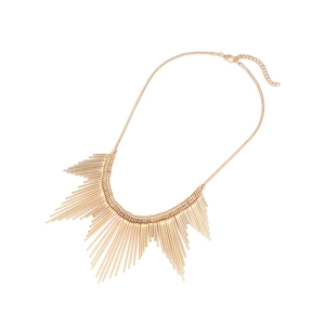 Macro detail of golden metallic fringe necklace with sunburst spiky design and snake chain