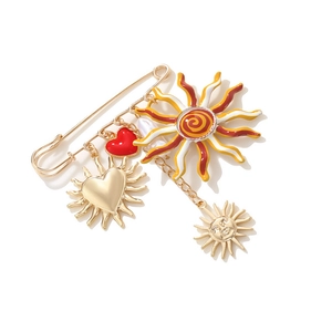 Golden safety pin brooch featuring enamel sun pendants and red heart charms for women