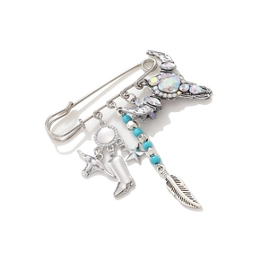 Western cowboy style safety pin brooch with bull skull and feather charms in silver