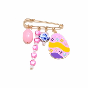 Exaggerated golden safety pin brooch with Easter egg, heart and floral charms