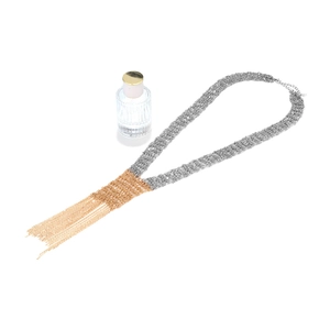 Detailed close-up of a dual-tone long fringe necklace with silver mesh and gold tassels