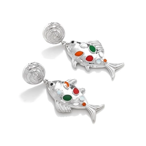 Detailed macro view of long alloy fishbone earrings with colorful enamel dot patterns