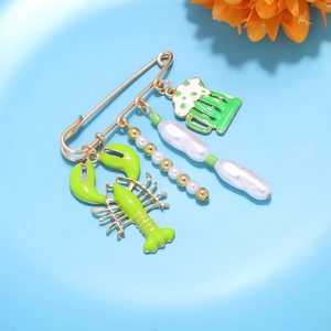 Nautical safety pin brooch with lobster and baroque pearl charms on blue background