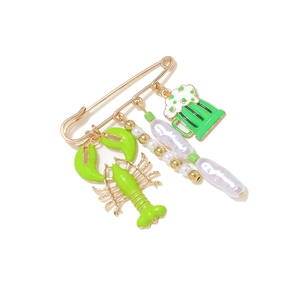Gold pin brooch with green lobster and beer mug charms featuring white imitation pearls