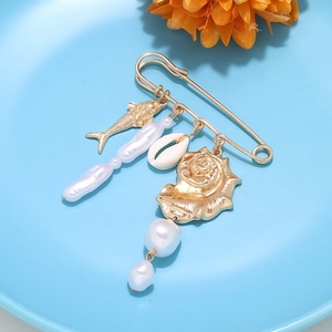 Detail of marine safety pin brooch with golden fish, baroque pearls and natural seashell