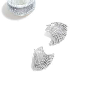 Silver shell-shaped stud earrings with wavy texture and polished metallic finish