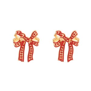 Elegant gold bow earrings with red enamel and sparkling crystal inlay on white background