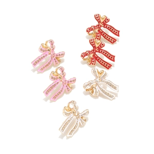 Elegant enamel bow earrings with sparkling crystals in pink red and white colors