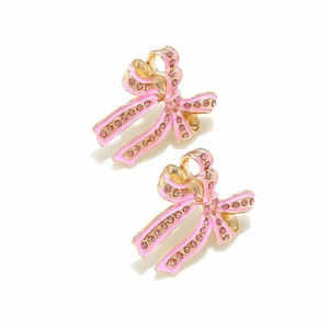 Detailed view of pink enamel bow earrings with sparkling crystals in gold plating