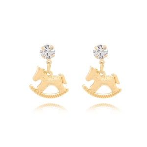 Detail of gold rocking horse earrings with hammered texture and sparkling crystal stud