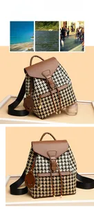Detail of houndstock fabric backpack with brown leather trim and a smile charm