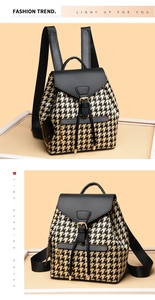 Detail of houndstooth backpack featuring black leather flap and gold buckle closure