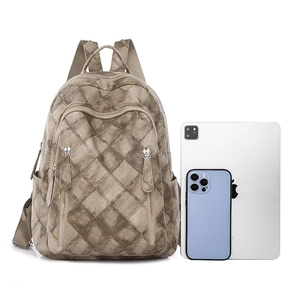 Brown quilted PU leather backpack for women with tablet and phone for size reference