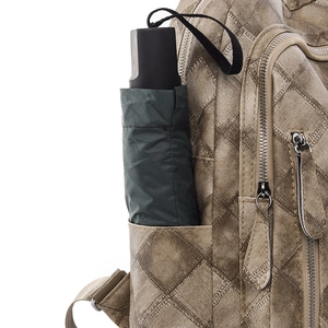 Brown faux leather backpack with quilted pattern and side pocket for umbrellas
