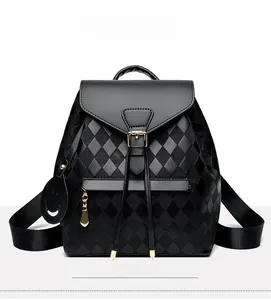 Front view of black quilted faux leather backpack with drawstring closure and metal buckle