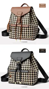 Detail view of retro houndstooth backpacks with leather flaps in brown and black finishes