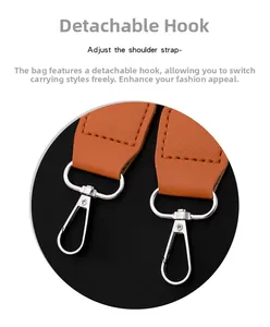 Detail of detachable silver metal lobster clasp and brown lychee leather shoulder strap