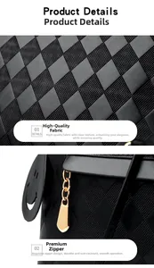 Detail view of black quilted faux leather fabric and smooth metal zipper with a charm