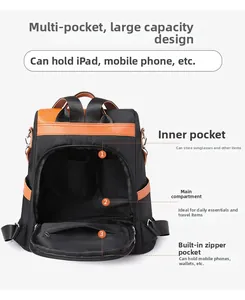 Detail view of spacious interior compartments in black nylon backpack with brown leather trim