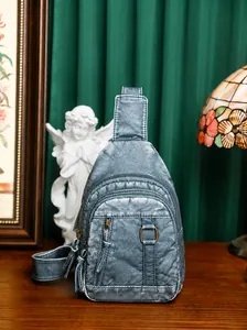 Detailed view of washed PU leather chest bag with retro bronze zippers and layered pockets
