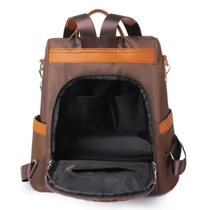 Women's dark brown contrast backpack showing interior main compartment with pockets