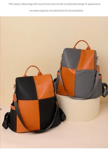 Detailed view of color-block pillow backpacks in black, orange and grey with sturdy handles