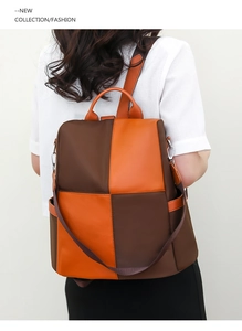 Detail of a color-block backpack in brown and orange with a secure anti-theft back opening