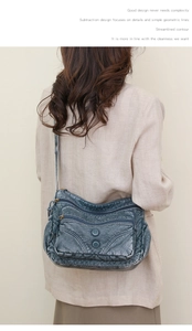 Detailed view of vintage washed PU leather shoulder bag worn over a beige suit