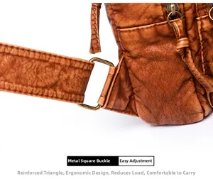 Detail of brown faux leather texture with bronze square buckle and reinforced stitching