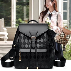 Chic black quilted leather backpack for women with gold zippers and smiling charm