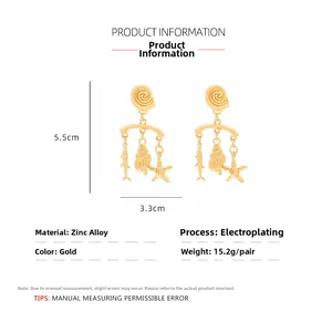 Detail view of gold ocean theme drop earrings showing shell and fish charms with dimensions