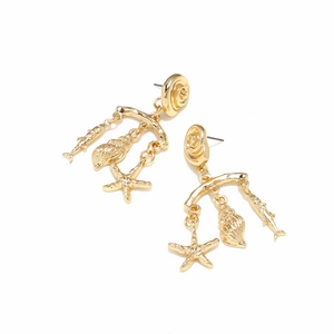 Gold tropical ocean earrings with starfish, shell, and fish charms on white background