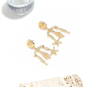 Gold ocean theme dangle earrings with seashell, starfish, and tropical fish charms