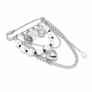 Detail of silver safety pin brooch with multi-layer chains, faux pearls and heart charms