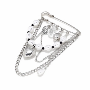 Gothic heart brooch with silver chains and baroque pearls on minimalist white background