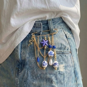 Ceramic starfish tassel brooch with printed beads on denim jeans, bohemian chic accessory