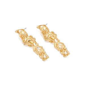 Macro shot of long gold earrings featuring artistic organic lava texture and metallic finish