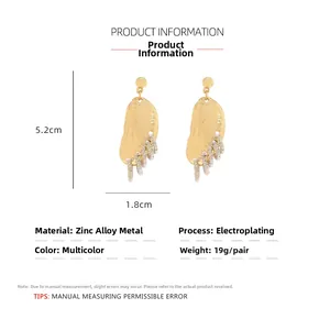 Detail view of gold irregular geometric shell earrings showing dimensions 5.2cm height