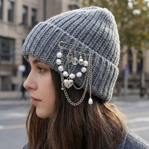 Grey knit beanie with pearl heart pin and tassel chain charms in punk street style