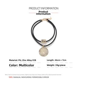 Detail showing dual-layer black PU cord with golden alloy coin and rectangular metal slide