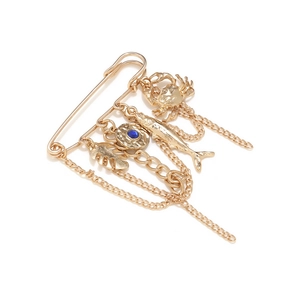 Vintage gold safety pin brooch with crab, fish, leaf pendants and blue gemstone