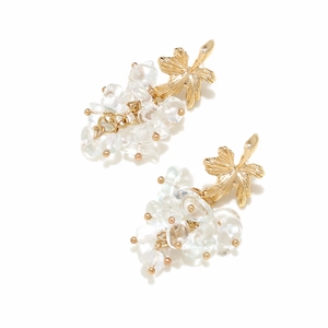 Detail of bohemian gold leaf earrings with clustered transparent gravel stone beads