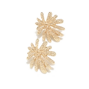 Macro shot of gold-plated firework earrings showing textured finish and coral-like shape