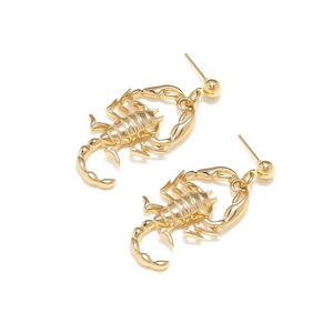 Detailed close-up of polished gold-tone alloy scorpion earrings with smooth metallic finish