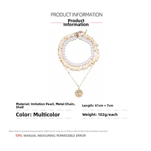 Detailansicht der mehrlagigen Boho-Halskette mit Muschel, Perle und Sonnenanhänger